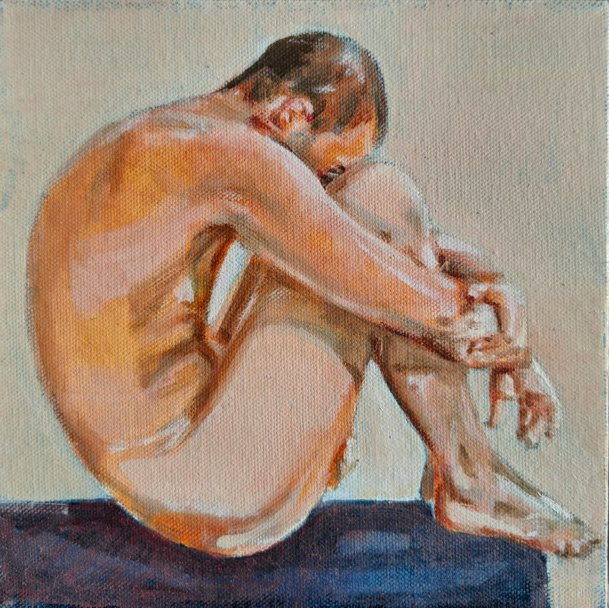 An oil painting of a seated nude male figure curled inward, rendered in warm flesh tones against a neutral beige background with a dark blue surface beneath.